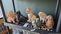 Seven animal figures on shelf showing overall lot