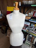 Front view of dress form torso on pedestal
