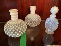 Three hobnail glass pieces on shelf