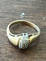 Top view of 10k gold ring showing cluster setting and hallmark