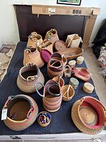 Overview of all baskets, boxes and bracelets laid out on surface