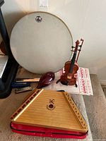 Group shot showing ocean drum, hand harp, violin, harmonica, maraca, sheet music