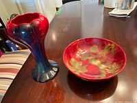 Vase and dish together on table