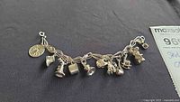 Full view of sterling silver charm bracelet with all charms visible