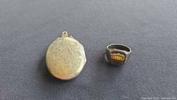 Ring and locket side by side for scale and overview