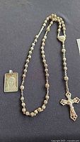 Rosary and Mary pendant laid out
