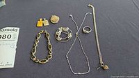 All seven jewellery items laid out on dark surface