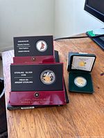 Overview of three Royal Canadian Mint sterling silver 50-cent coins with their original packaging displayed on table