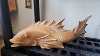 Right side view of carved wood fish