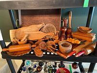 Shelf view showing majority of wooden items including trays, boards, rolling pins, mortars, mills and bowls