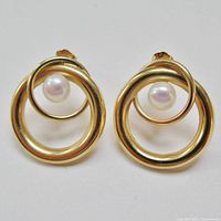 Front view of both earrings displaying intertwined hoops and pearls
