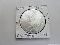 Obverse of coin in 2×2 holder, Queen Elizabeth II portrait