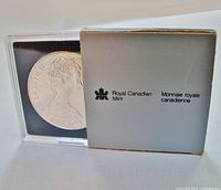 Coin in case with outer sleeve showing Royal Canadian Mint logo