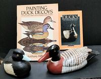 Group shot of both decoys and two books