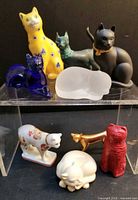 Group shot of all nine Franklin Mint cat figurines showing variety of materials and colours