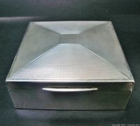 Top view showing engine-turned sterling silver lid and square form