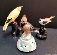 All three ceramic bird flower frogs front view