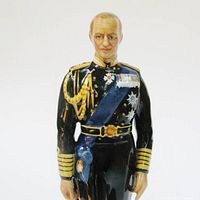 Front view of glazed porcelain figurine of Prince Philip Duke of Edinburgh in naval uniform