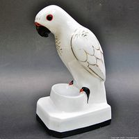 Left side view of white porcelain parrot perfume lamp on stepped base