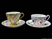 Both Shelley teacup and saucer sets side by side