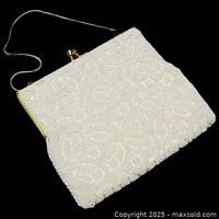 Front view of white beaded evening bag with chain handle