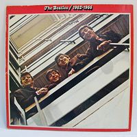 Front gatefold cover showing 1962 balcony photo and red border