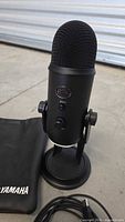 Front view of Blue Yeti microphone on stand with pouch partially visible