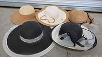 All five hats laid out showing colours and styles