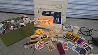 Overall lot with sewing machine, green sewing box full of spools and accessories