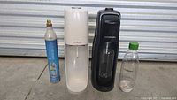 Group shot of both SodaStream makers, one bottle, one CO2 cylinder