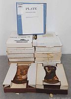 Stack of 10 presentation boxes, certificate booklet visible