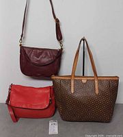 Front view of three Fossil bags showing colors and styles
