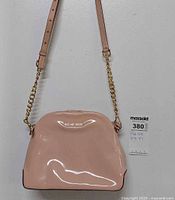 Front view showing overall bag, strap, and hardware