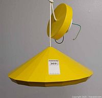 Front view of yellow conical pendant lamp with canopy