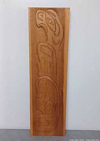 Front view of carved wood Haida wall panel