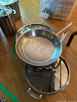 Three stainless steel pans with two lids