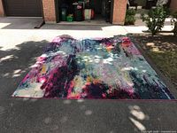 Full view of rug laid flat on driveway