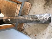 Rolled rug wrapped in plastic