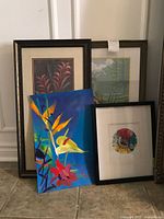 Group shot showing all four artworks leaning against wall