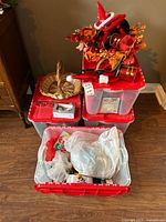 Four storage totes filled with assorted holiday items