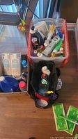 Overview showing three containers with assorted cleaning supplies and Swiffer pads