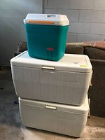 Front view of stacked coolers showing Rubbermaid on top of two Coleman units