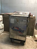 Front view showing AmeriQue logo, control panel, casters, stains