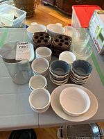 Overview of lot showing canister, ramekins, escargot dishes, custard cups and plates