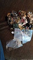 Overall pile of assorted costume jewelry on fabric surface