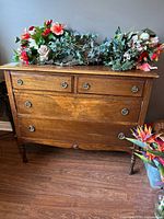 Front view of wood dresser with four drawers and metal pulls