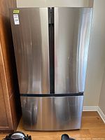Front view of stainless steel Hisense French-door refrigerator with bottom freezer drawer closed