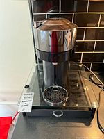 Front view of Nespresso Vertuo Next on pod drawer