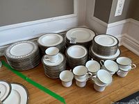 Stacks of plates, bowls, cups and saucers on floor