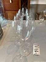 Row of twelve clear crystal wine glasses on table
